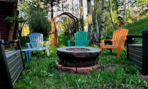 A cozy fire pit in the backyard of a rustic cabin, providing warmth and ambiance for outdoor gatherings.