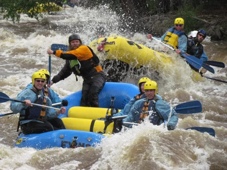 A group of people enjoying rafting down a river.